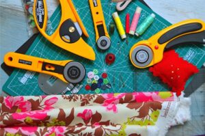 Qulting cutting mat with rotary cutters and fabric